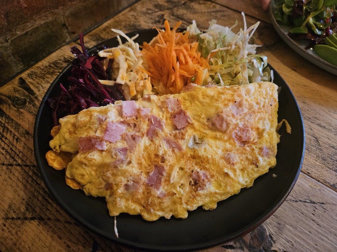 A ham and cheese omelette at Nilly's Cafe served with a fresh side salad of carrot, cabbage and red slaw.